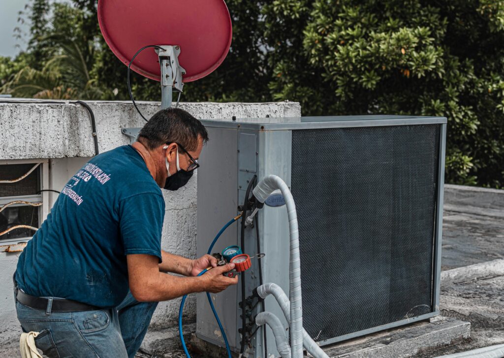 the blue shirt man can checking air conditioner gas for air conditioner service in chennai