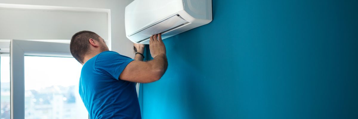 the blue t-shirt man as done the air conditioner service on the blue wall